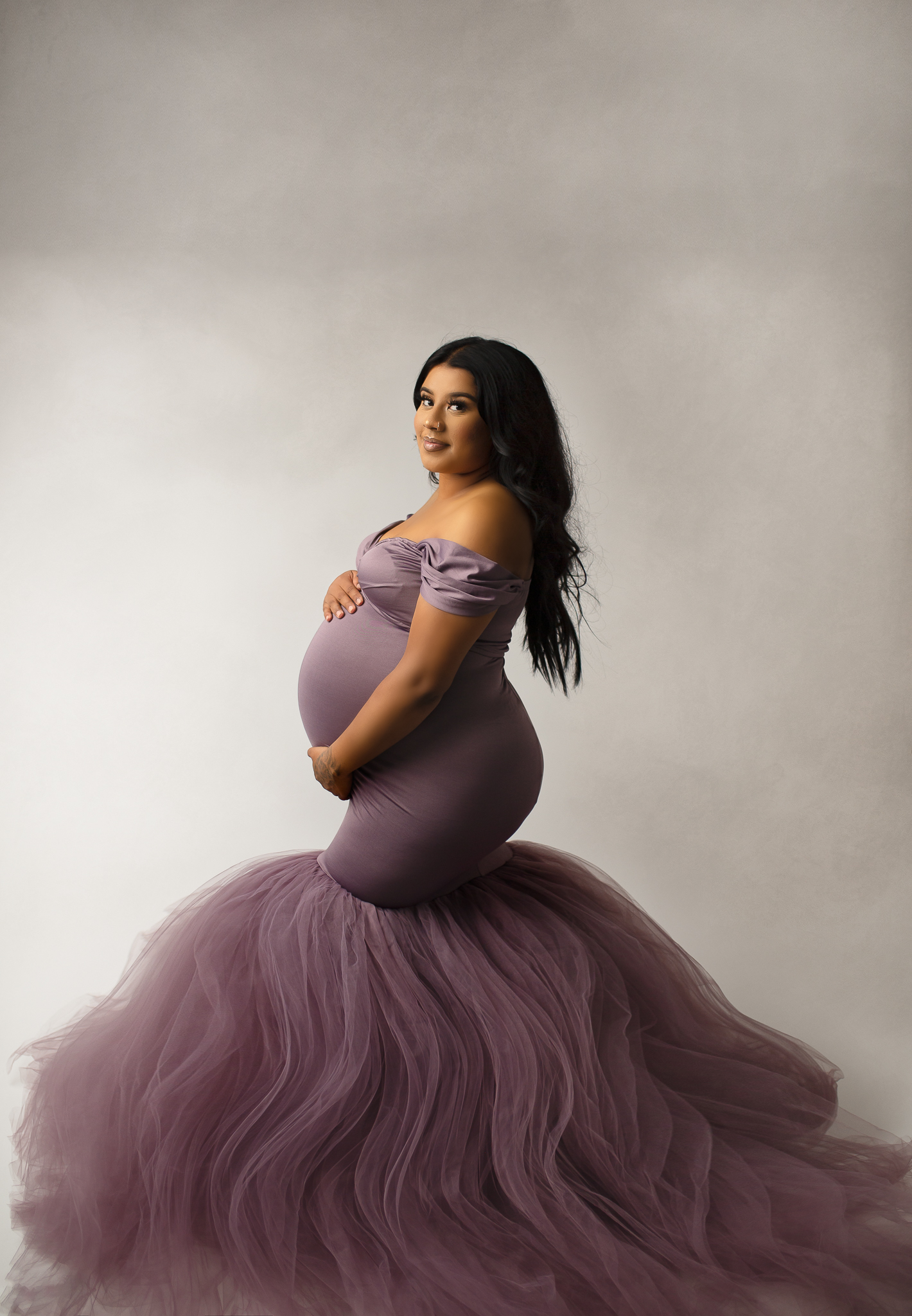 Pregnant mom wearing purple gown